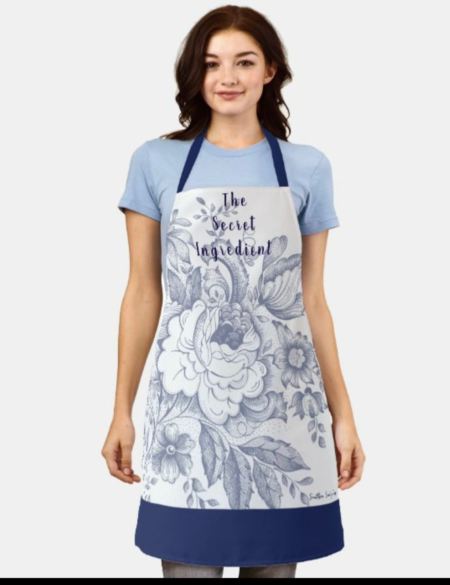 "The Secret Ingredient" Blue Floral Apron (Size Medium).   $30.00