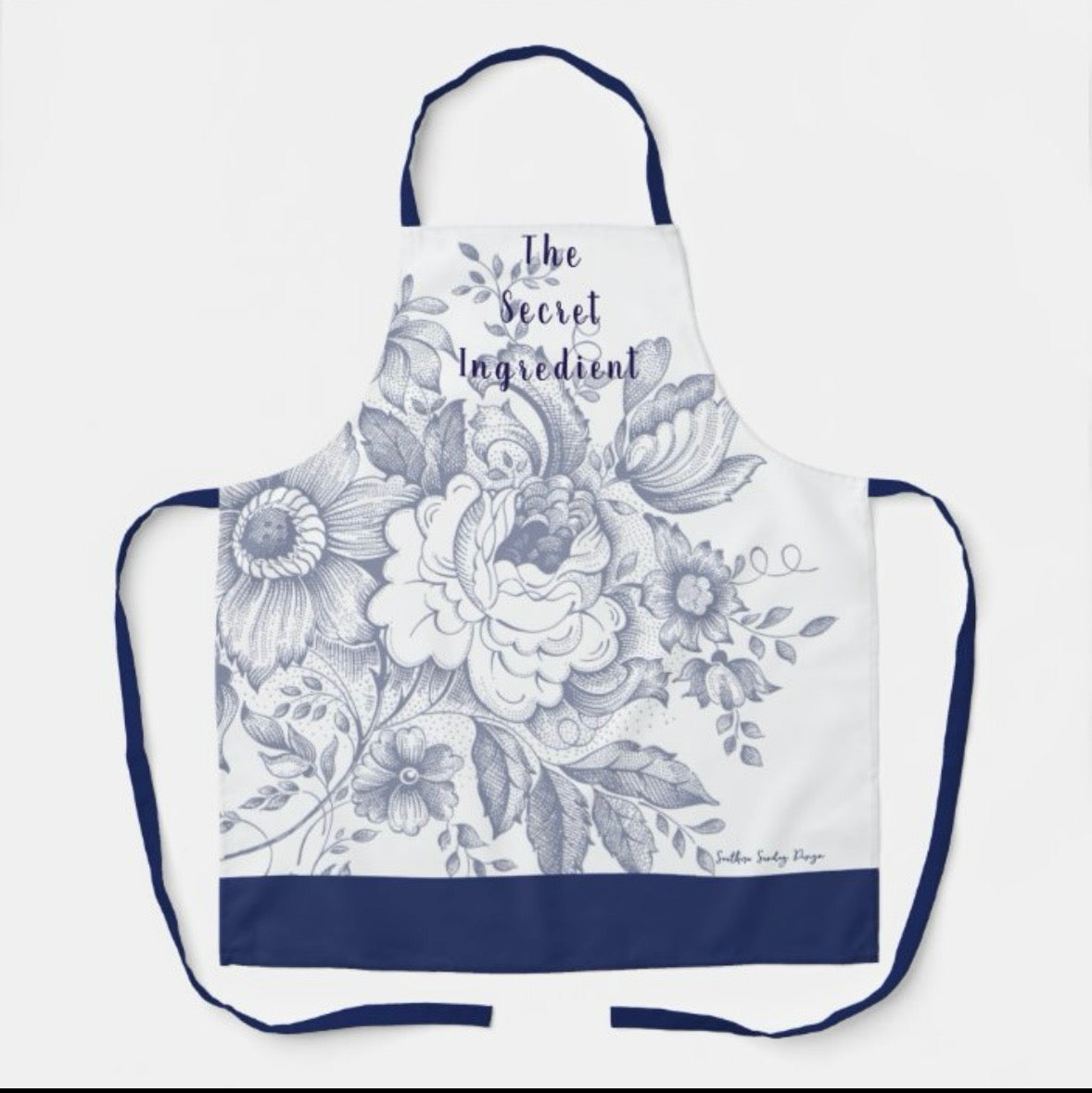 "The Secret Ingredient" Blue Floral Apron (Size Medium).   $30.00